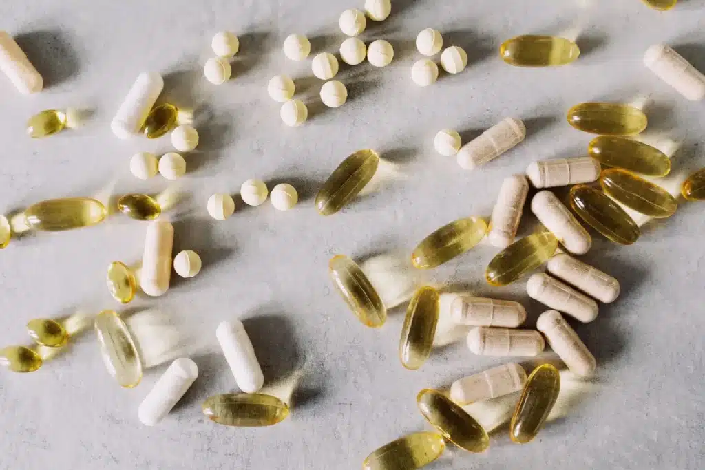 Rayons de pharmacie avec des bouteilles de compléments alimentaires et vitamines colorées