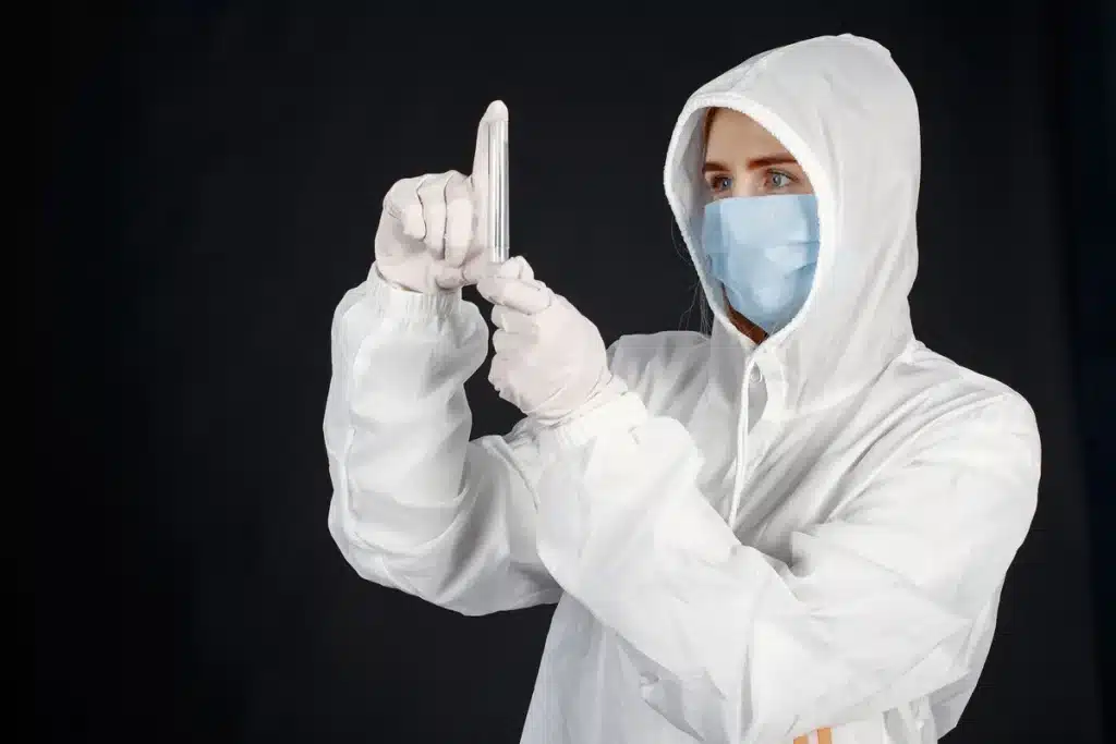 Professionnel de santé portant gants et masque, préparant un test médical en laboratoire
