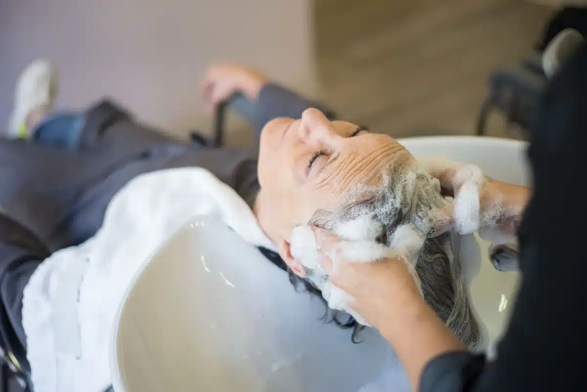 Application de shampooing sur cheveux secs et huilés avant rinçage