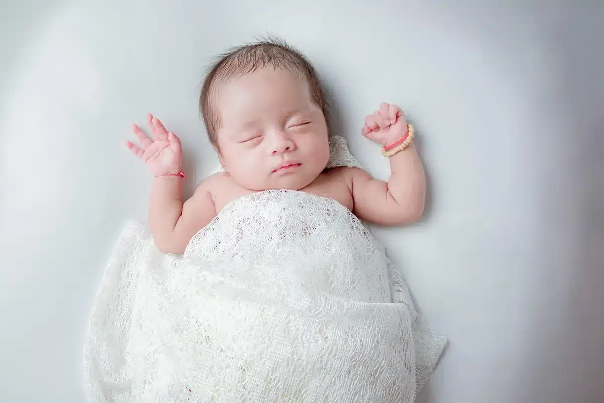 Personne dormant paisiblement dans un lit, illustrant l'effet apaisant du bruit blanc pour favoriser le sommeil.