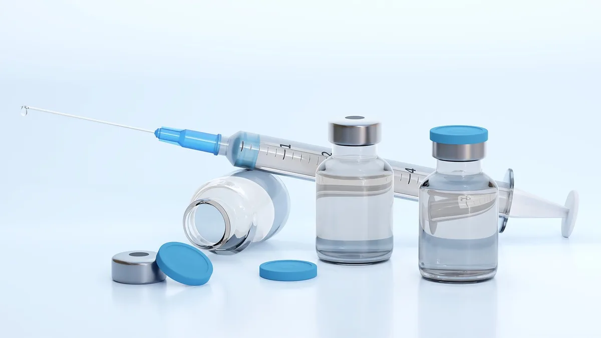 Flacons et étiquettes de vaccins alignés sur une table